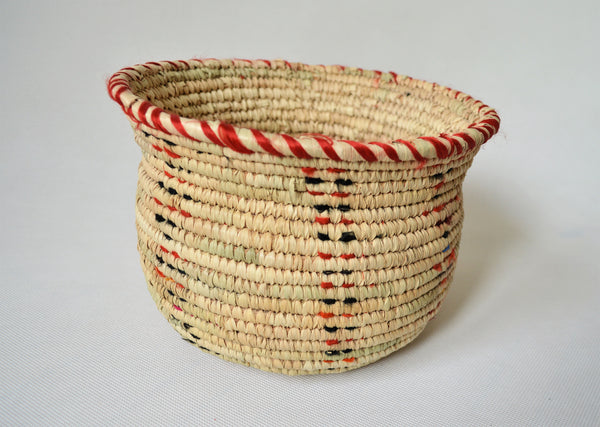 Wide woven bowl decorated with red and black fabric